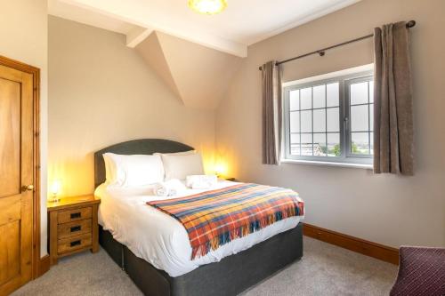 a bedroom with a large bed and a window at 3 Bed in Fulbeck oc-v33643 in Fulbeck