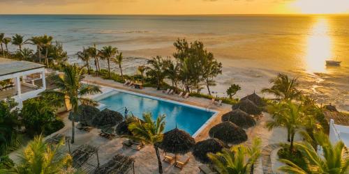 an aerial view of a resort with a swimming pool and the ocean at Kaskazi Hotel Zanzibar in Jambiani