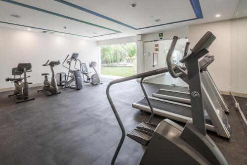 a gym with several treadmills and cardio machines at Wyndham Garden Playa del Carmen in Playa del Carmen
