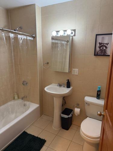 a bathroom with a sink and a tub and a toilet at Chic Times Square 1BR Entire Apt - Private Kitchen & Bath - Hosts 4 in New York