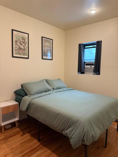 a bedroom with a bed and a window at Chic Times Square 1BR Entire Apt - Private Kitchen & Bath - Hosts 4 in New York