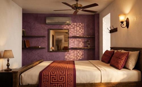 a bedroom with a bed and a ceiling fan at Vp residency in Bangalore