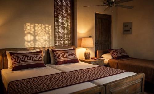 a bedroom with two beds and a lamp in it at Vp residency in Bangalore