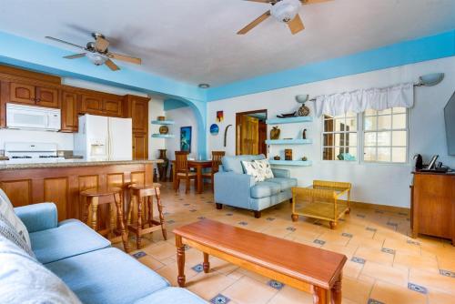 a living room with a couch and a table at Beachfront 2BR Villa with Pool & Spacious Layout in Placencia