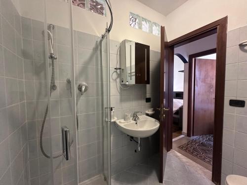 a bathroom with a sink and a shower at L'Angolo di Luce in Falconara Marittima