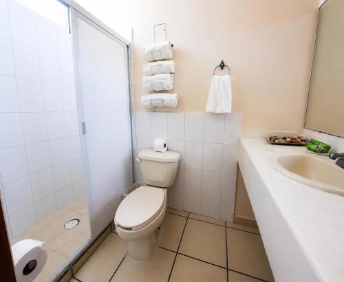 a bathroom with a toilet and a sink at Dpto Exclusive Ixtapa in Ixtapa