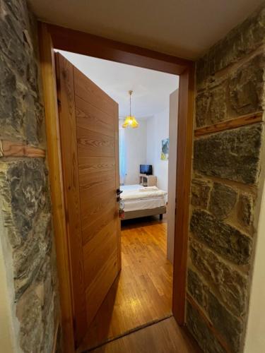 an open door into a room with a bedroom at Albergo Brustolon in Dont