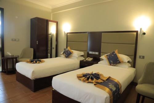 a hotel room with two beds with bows on them at Nile View Hotels in Bahir Dar
