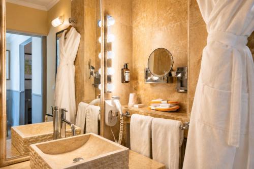 a bathroom with a sink and a mirror at Ermitage De Corton - Teritoria in Chorey-lès-Beaune