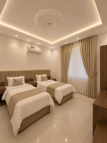 a hotel room with two beds and a window at Comfort Stay 3 in Taif