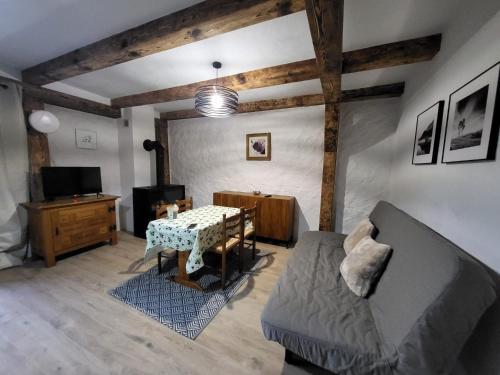 a living room with a table and a couch at Barn - Nocleg na Mazurach in Sołtmany