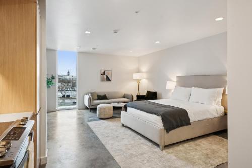 a bedroom with a bed and a living room at Placemakr Salt Lake City Downtown, Apartments by Hilton in Salt Lake City