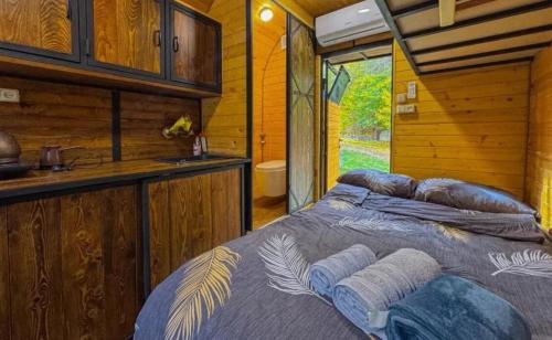 a bedroom with a bed in a log cabin at Loft Dilijan in Dilijan