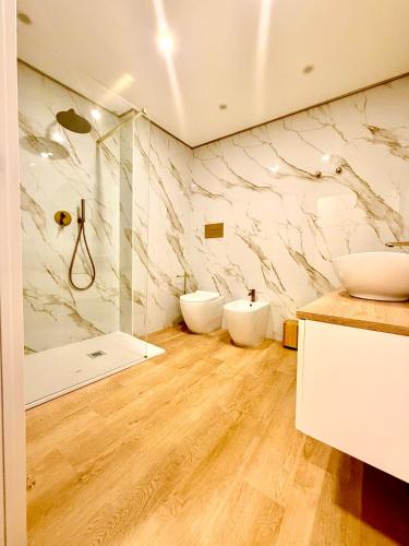 a bathroom with two sinks and a shower at Le Charme Luxury Suite in Patti