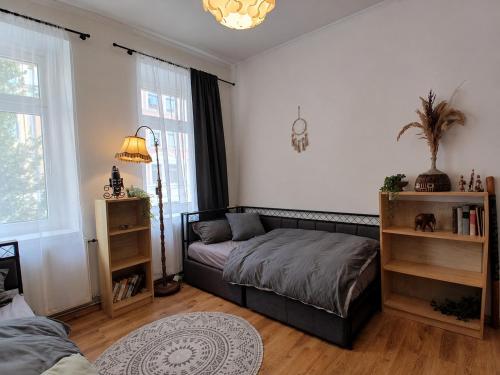 a bedroom with a bed and a book shelf at The Boho Hideaway in Leutsch in Leipzig