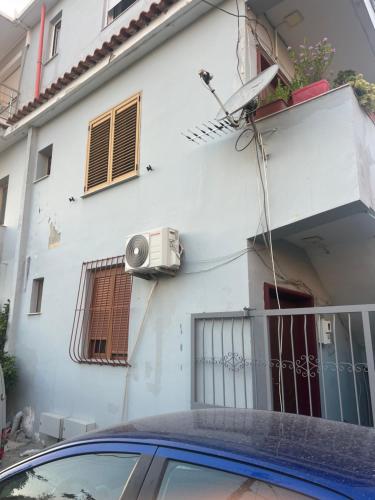 a car parked in front of a white building at Eljo Apartment in Asim Zeneli