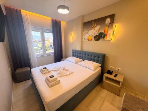 a small bed in a room with a window at London Restaurant Hotel in Kukës