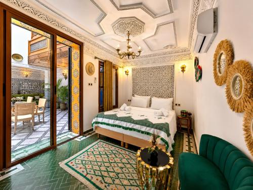 a bedroom with a bed and a balcony at Riad Dar ElBellar in Fez