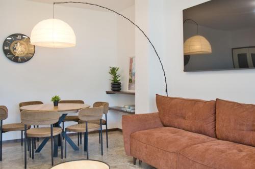 a living room with a couch and a table and chairs at Renzo e Lucia - la Terrazza Panoramica in Barzio