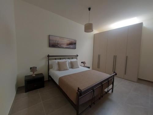 a bedroom with a large bed and a cabinet at Dani & Fani suite in Afantou