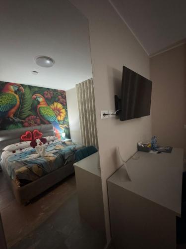 a room with a bed with a painting on the wall at The Paris Rooms B&B in Reggio di Calabria