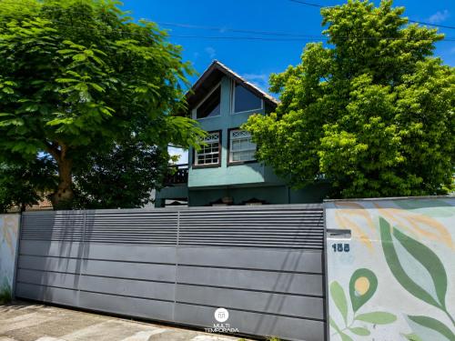 a fence in front of a house at Pousada Solar das Pétalas - Florianópolis/SC in Florianópolis