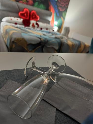 a pair of pictures of a glass object next to a bed at The Paris Rooms B&B in Reggio di Calabria