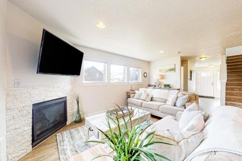 a living room with a couch and a flat screen tv at Dory Pointe Dream in Pacific City