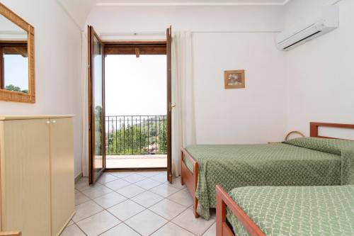 a room with two beds and a balcony at Limoneto by Espresso Rentals in Massa Lubrense