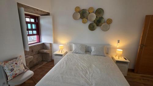 a bedroom with a bed and two tables with lamps at In Viana in Viana do Castelo