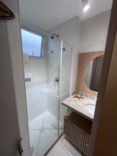a bathroom with a shower and a sink at Village Baixio Garden in Baixio