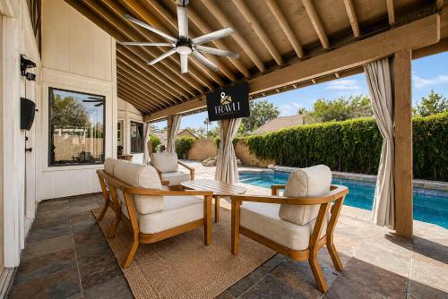 a dining room with a table and chairs and a pool at NEW Royal Palms Retreat with Pool Spa & Pool Table in Tempe