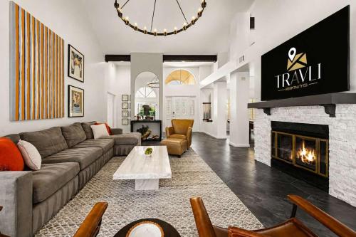a living room with a couch and a fireplace at NEW Royal Palms Retreat with Pool Spa & Pool Table in Tempe