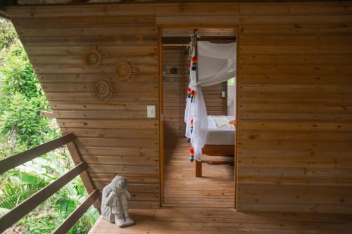 a wooden room with a bed in a wooden house at Madre Selva Eco Lodge in Nuquí