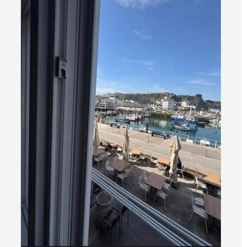 a view of a beach from a window at La Casina del Puerto in Luarca
