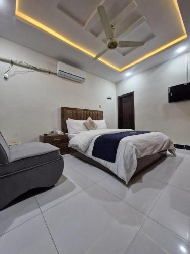 a bedroom with a bed and a couch at Abu Khalid By MZ Hotels & Restaurant in Mingāora