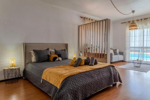a bedroom with a large bed with a large window at Canto Celeste in Alcobaça