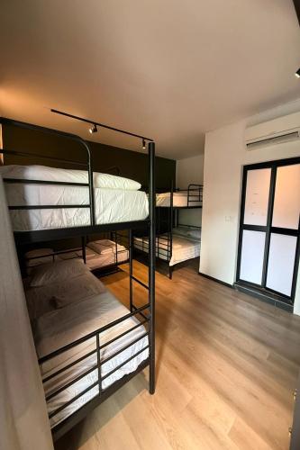 a group of bunk beds in a room at GoStay Pods at Perak Road in Singapore