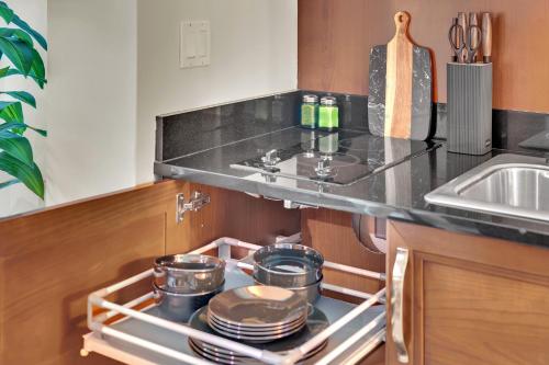 a kitchen with a stove with pots and pans at Luma Vera Penthouse Sanctuary Strip Views in Las Vegas