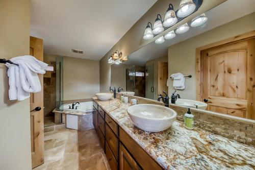 a bathroom with two sinks and a large mirror at Brian Head 'View-Topia' w/ Mtn Views & King Suite in Brian Head
