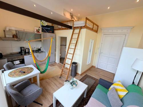 a living room with a loft bed and a hammock at Gemütliches Apartment in zentral mit Balkon in Bremen