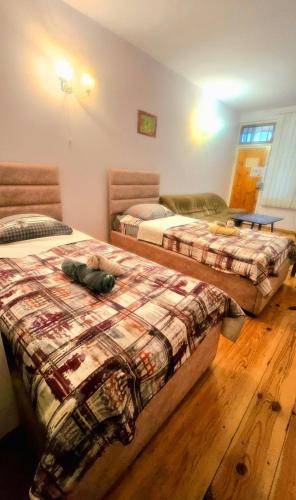 two beds in a room with wooden floors at ASINE Dilijan in Dilijan
