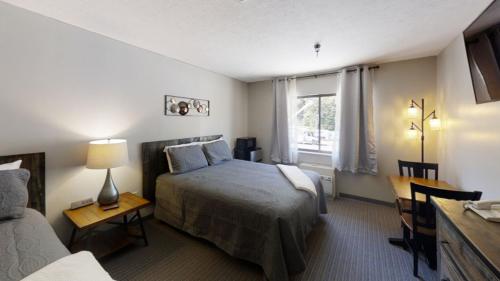 a hotel room with a bed and a window at Inn at Snowshoe in Snowshoe