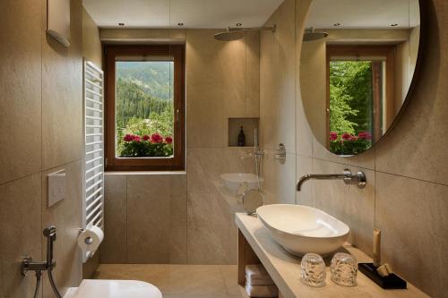 a bathroom with a sink and a mirror at Chalet Vanzi in San Martino in Badia