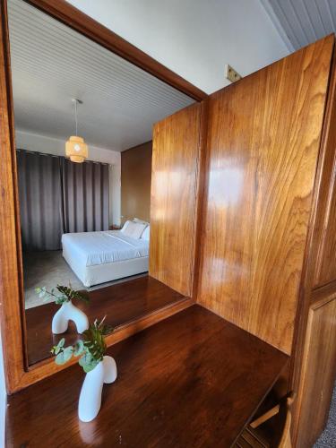 a bedroom with a mirror and a bed in it at Tropical Breeze Apartments in Paramaribo