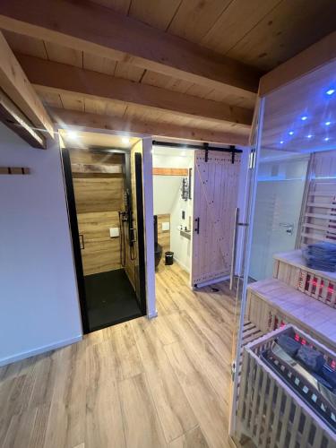 a room with wooden floors and wooden walls at Gästeappartements Mechels in Wilnsdorf