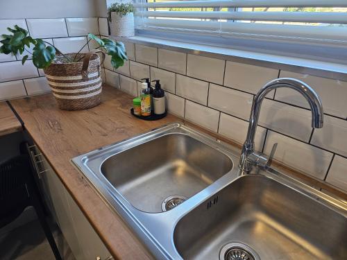 a stainless steel sink in a kitchen with a window at Rosa's Self-catering Unit 2 in Springbok