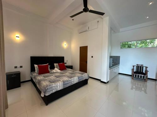 a bedroom with a bed and a ceiling fan at Cinnamon Ridge Unawatuna in Unawatuna