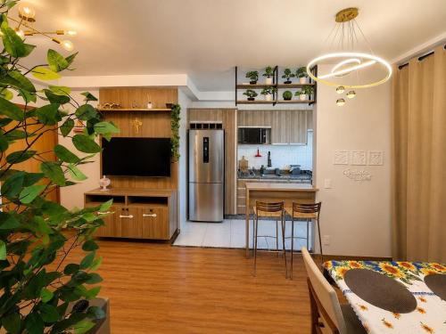 a kitchen and living room with a table and chairs at Recanto Augusta in Londrina