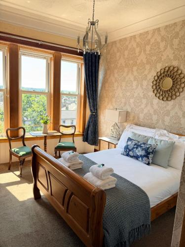 a bedroom with a bed with towels on it at Castle Walk Bed & Breakfast in Stirling